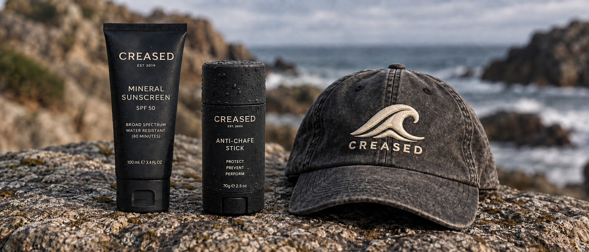 Creased Mineral Sunscreen,Anti-Chafe Stick and Creased cap on coastal rock